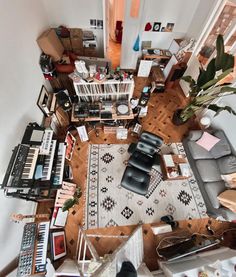 an overhead view of a living room with piano, couch and other items on the floor