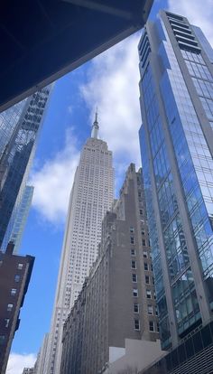 skyscrapers in new york city with blue sky and clouds