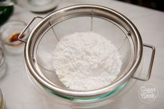 a strainer filled with flour on top of a table