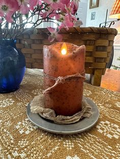 a lit candle sitting on top of a plate