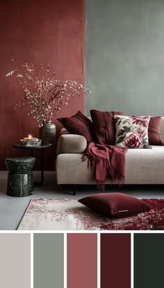 a living room with red and grey walls, couches, rugs and pillows