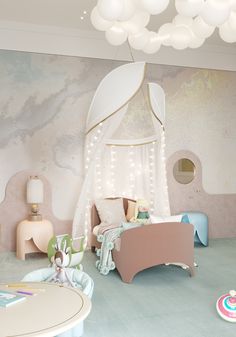 a child's bedroom decorated in pastel colors and with white balls hanging from the ceiling