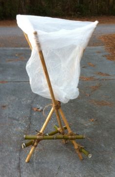 a white cloth covered chair sitting on top of a sidewalk