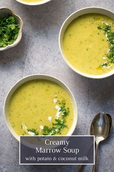 three bowls filled with soup on top of a table next to silver spoons and green leafy garnish