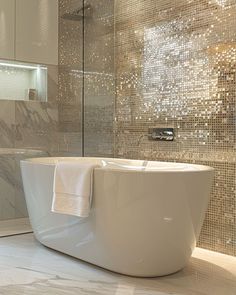 a bathtub sitting in the middle of a bathroom next to a walk in shower