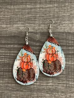 "Fall Fest Triple Pumpkins Teardrop Earrings.  Made from MDF Board, PRINTED & Sublimated at extremely high heat and are made to LOOK DIMENSIONAL, but are actually flat and extremely light weight and can be worn for extended periods of time. Earrings are approximately 1 3/4\" wide and 2 3/4\" - 3\" long.  Design is the same on both sides.   Be sure to look at this and many other designs on our website as well:  crosstrendsdesigns.com" Fall Fest, Polymer Jewelry, Leather Earrings, Christmas Shopping, Teardrop Earrings, Pink Floral, Jewelry Earrings Dangle, Etsy Earrings, Dangle Drop Earrings