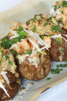 the baked potatoes are topped with cheese and parsley