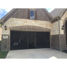 a large brick house with two garage doors