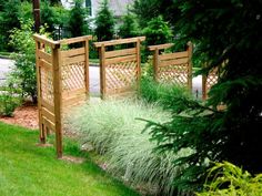 two wooden gates sitting next to each other in the grass