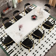 a dining room table with black chairs and a white marble top