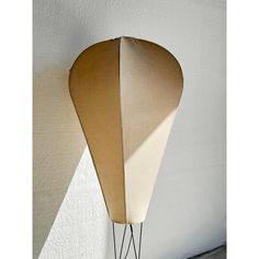 a lamp that is on the side of a wall with a shadow cast on it