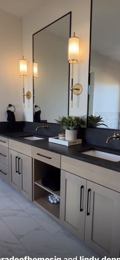 a bathroom with double sinks and large mirrors