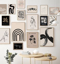 a wall with many different types of art on it and a table next to it