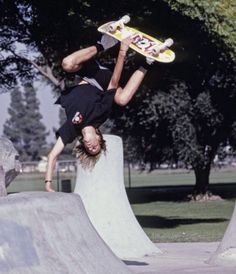 a man flying through the air while riding a skateboard on top of a ramp