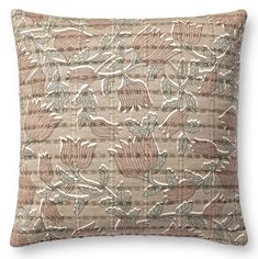 a beige and brown pillow with leaves on it