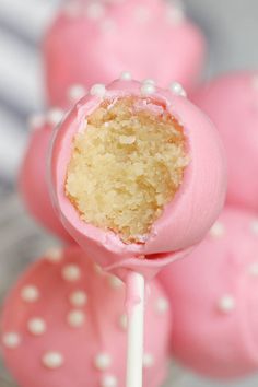 pink cake pops with white sprinkles on top