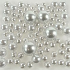 many shiny silver balls on a white surface