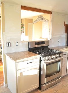 a kitchen with an oven, stove and cabinets in it