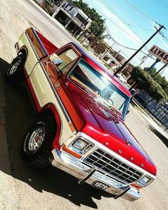 a red and white truck parked on the street