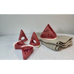 Pop Art Perfection! Juicy watermelon slice ceramic  napkin rings will add a touch of  Americana style to your table or picnic blanket!  So will the matching napkin holder!   Set of 5 includes:  DIMENSIONS  Napkin rings (4) 3”w 1”d 4”h  Napkin holder (1) 5”w 2.5”d 4.5”h Cute Napkin Holder, Clay Ring Holders, Clay Napkin Holder, Watermelon Ceramic, Sliced Watermelon, Ceramic Napkin Holder, Ceramic Napkin Rings, Juicy Watermelon, Beginner Pottery