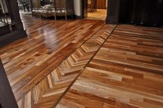 a wooden floor in a house with hard wood floors and black trim on the walls