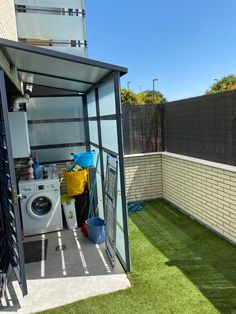 an outdoor laundry area with washing machine and dryer