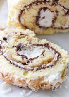 a cinnamon roll is cut in half and sitting on a white surface with icing