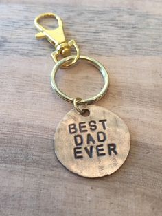 a metal keychain with the words best dad ever on it