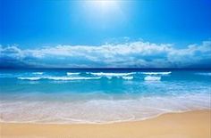 the sun shines brightly over an ocean beach with blue skies and white foamy waves