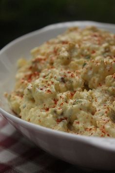 a white bowl filled with food on top of a table