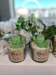 two small candles with green frosting in front of flowers