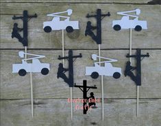 a group of wooden crosses sitting on top of a table next to a cross and a truck