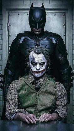 the joker and batman character are sitting in front of a brick wall