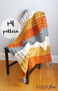 a crocheted blanket sitting on top of a wooden chair