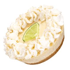 a cheesecake topped with whipped cream and a lime slice