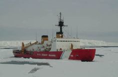 a red and white boat sitting on top of snow covered ground next to an ice floe