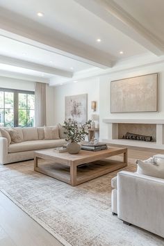 a living room with couches, coffee table and fireplace