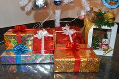 several wrapped presents under a decorated christmas tree