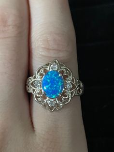 Victorian style filigree oval Blue Opal and White Topaz Accented Ring  Metal: 925 Sterling silver Size: 8.5 Weight: 3.05 g Stones: Blue Opal and 4 White Topaz Classic Opal Ring With Accent Stones, Oval Cabochon Filigree Jewelry For Anniversary, Ornate Oval Filigree Ring Stamped 925, Elegant Oval Filigree Ring With Birthstone, Oval Opal Ring In Fine Jewelry Style, Heirloom Oval Filigree Ring Stamped 925, Oval Filigree Ring With Birthstone For Anniversary, Formal Opal Ring Stamped 925, Oval Opal Ring Fine Jewelry