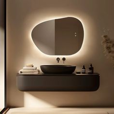 a bathroom with a sink, mirror and lights on the wall above it's counter