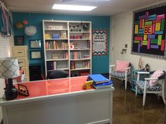 a room with several chairs and bookshelves in it