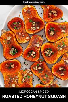 roasted honeynut squash on a white plate with text overlay that reads moroccan - spiced roasted honeynut squash