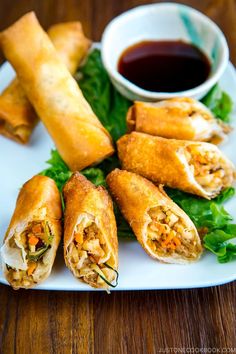 some food on a white plate with dipping sauce