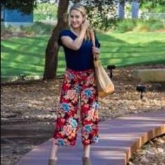 Breezy, Flowy, Cool, And Soft. These Pants Are A Fun Addition To Any Wardrobe Thanks To It's Fun, Striking Colors. Looks Great With Blouses, Tees; Even Sleeveless Sweaters And Fitted Turtlenecks. Floral Pattern On Navy Blue Background. Fabric Has A Great Texture And Weight. Zip Front. Waist Closure Is Button And Hook And Bar. Pockets Are Still Basted Shut. Tags Removed, But Never Made It Out Of My Closet. Flat Lay Measurements Are Approximate. Waist: 16.5" Rise: 10" Inseam: 21" Casual Red Summer Capris, Casual Red Floral Print Bottoms, Sleeveless Sweaters, Fitted Turtleneck, Background Fabric, Wide Leg Cropped Pants, Navy Blue Background, Sleeveless Sweater, Blue Background