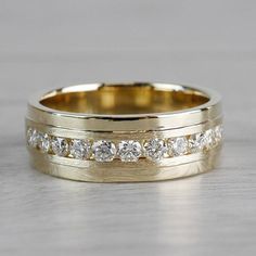 two yellow gold wedding bands with white diamonds