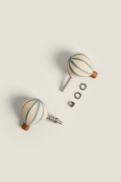 two white and blue striped round knobs on top of each other with screws