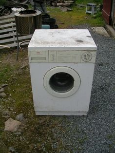 an old washing machine sitting on the ground