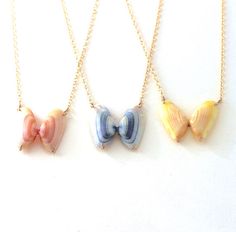 three necklaces with different colors and designs on them