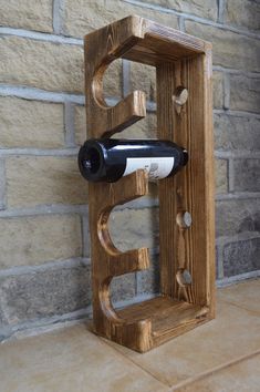 a wine bottle holder made out of wood