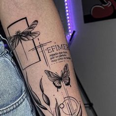 a woman's arm with a cross and two butterflies on it, which reads feimer